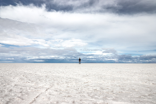 A man stands in the middle of the Salar De Uyuni, the largest salt flat in the world, in January 2023.