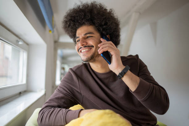 Happy young man using phone stock photo