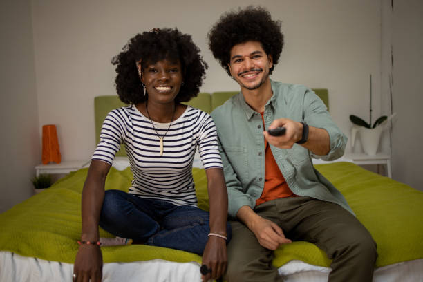 istock Young couple watching TV 1464288745