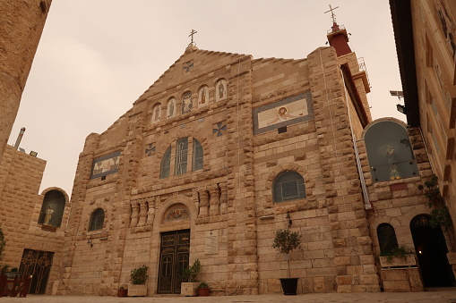 Facade of the St. John the Baptist Roman Catholic Church in Madaba, Jordan 2021