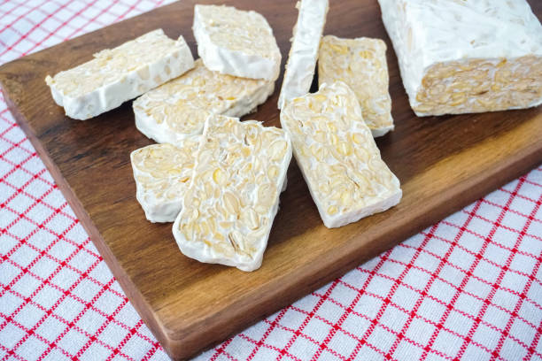 istock Raw Tempeh or Tempe Slices on Wooden Background and Pattern Napkin 1464301905