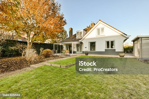 istock a backyard with a lawn and a house 1464305544