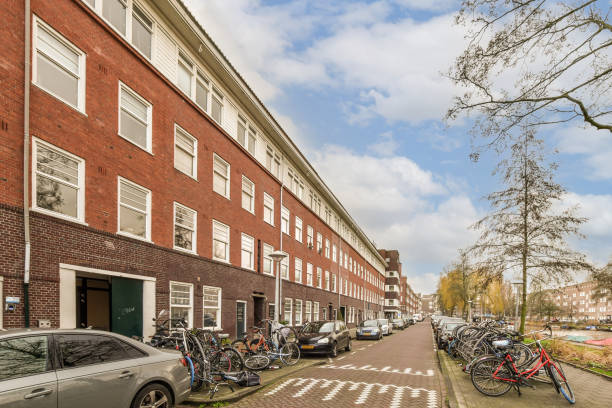 istock a row of tall brick buildings with bikes parked on 1464308573