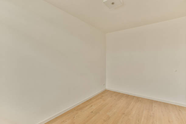 istock an empty room with wooden floors and white walls 1464308689