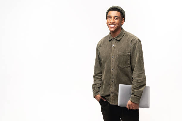 istock Overjoyed excited man holding laptop while looking at camera with happy smile. Indoor studio shot isolated on white 1464308777