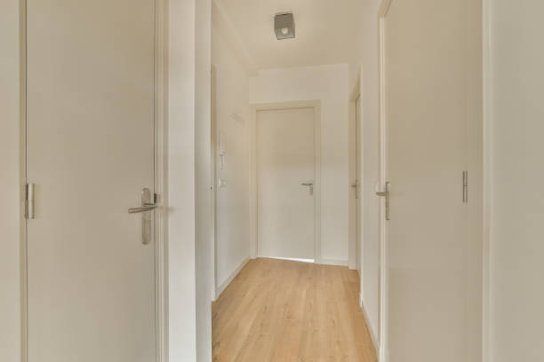 istock a corridor in a home with white walls and wood 1464309394
