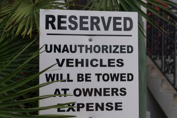 istock Signage with Reserved Unauthorized Vehicles Will Be Towed at Owners Expense- Destin, Florida 1464310242