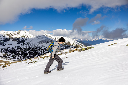 Young Boy Hiking on the Snow at  the top of Whistlers Mountain, Alberta, Canada on a nice day of summer.