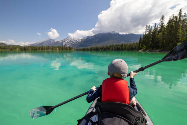 istock Cute Little Boy Paddleboarding on Edith Lake, Jasper National Park, Alberta, Canada 1464313906