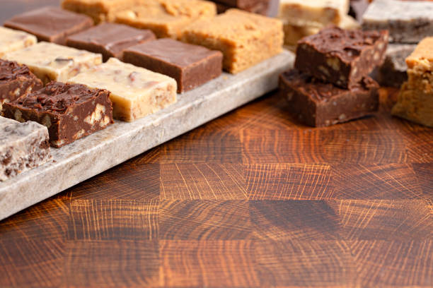 An Assortment of Various Flavors of Fudge on a Wooden Butcher Block Assortment of Various Flavors of Fudge on a Wooden Butcher Block fudge stock pictures, royalty-free photos & images