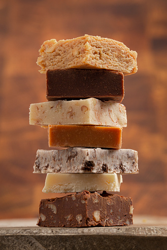 A Stack of Six Different Types of Fudge with a Butcherblock Background