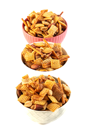 Serving of Homemade Cereal Nut and Prezel Trail Mix Isolated on a White Background