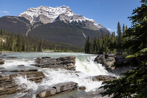 Athabasca Falls. Athabasca Falls is a waterfall in Jasper National Park on the upper Athabasca River on a beautiful day of summer, approximately 30 kilometres south of the townsite of Jasper, Alberta, Canada