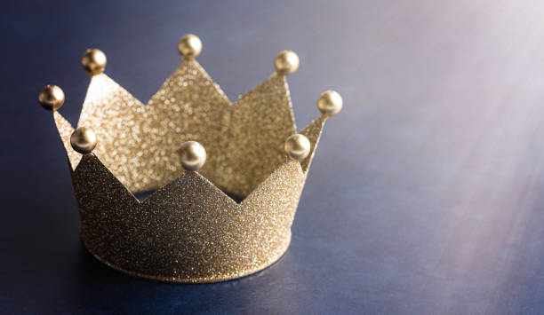 istock Classic Golden Crown on a Blue Table with Light 1464317615
