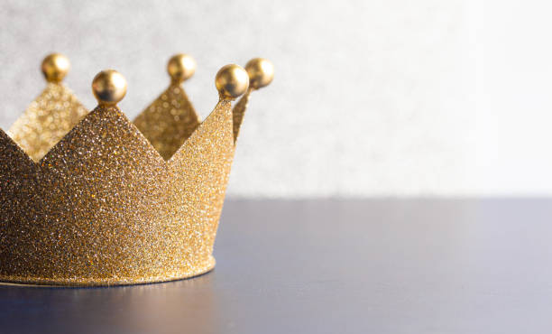 istock Classic Golden Crown on a Blue Table with Light 1464317624