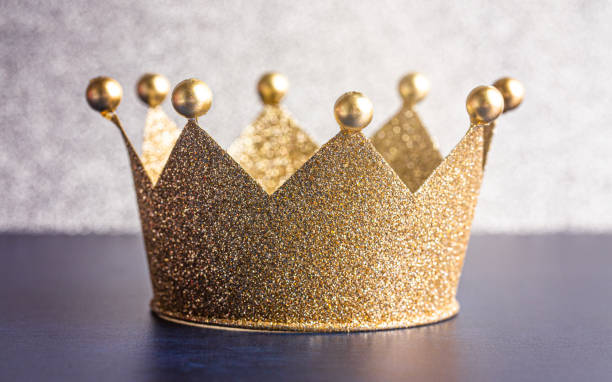 istock Classic Golden Crown on a Blue Table with Light 1464317625