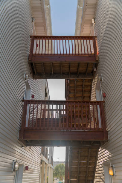 istock Stairwell in between two buildings with two landings and railings- Destin, Florida 1464317708