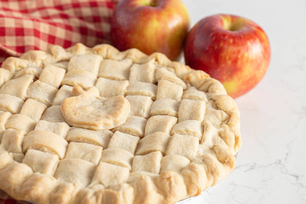 istock Handmade Apple Pie with a Lattice Top Crust on a Kitchen Counter 1464318691