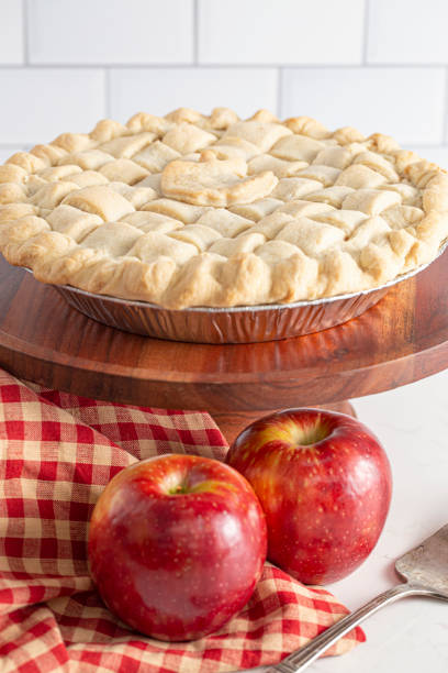 istock Handmade Apple Pie with a Lattice Top Crust on a Kitchen Counter 1464318699