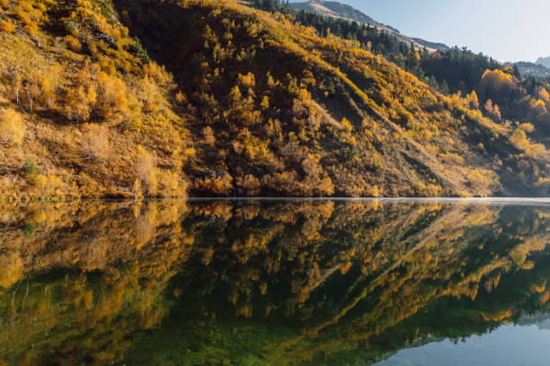 istock Mountain lake with reflection, autumnal fall trees and mountains 1464318705