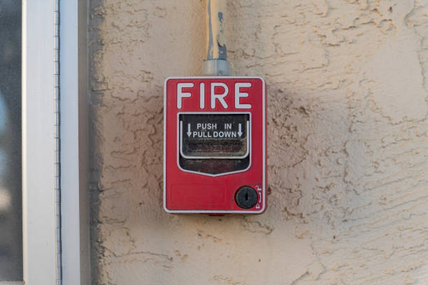 istock Fire alarm button mounted on a beige stucco wall in Destin, Florida 1464319434