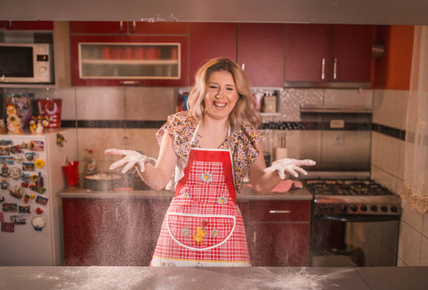 istock Happy woman having fun in the kitchen 1464320606
