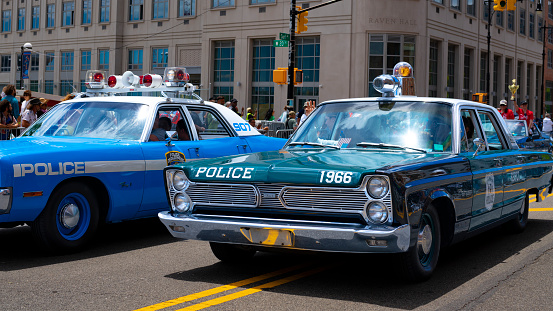 Coney Island, New York City, USA - June 18, 2022:    Antique police cars at Mermaid Parade, Surf Avenue, the largest art parade in the nation.