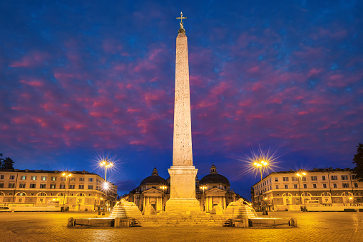 Piazza del Popolo in downtown Rome Italy illuminated at twilight.