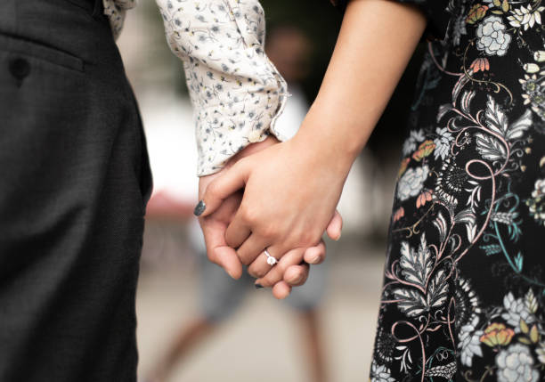 istock bride and groom wedding holding hand and rings 1464323931