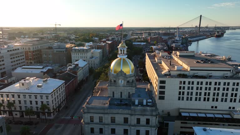 Aerial orbit of City Hall in Savannah Georgia at golden hour sunset.