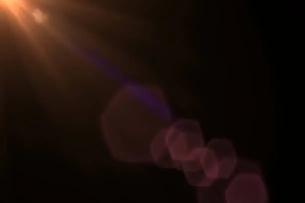 Photo of Digital sun rays light rendering isolated on the black background for overlay design or screen blending photo editing