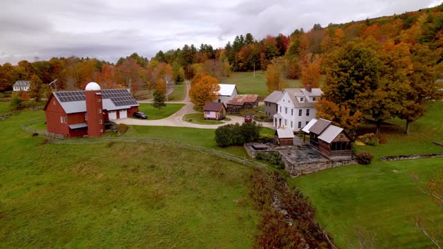 slow aerial push to vermont farm scene in fall