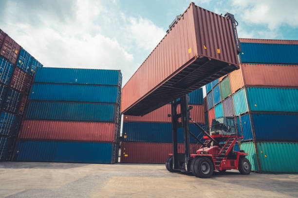 istock Cargo container for overseas shipping in shipyard with heavy machine . Logistics supply chain management and international goods export concept . 1464324387