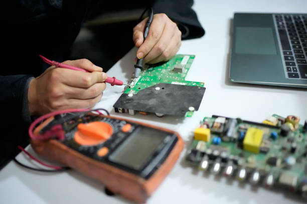 Researchers repairing circuit boards