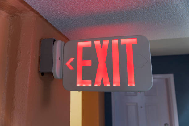 istock Red LED Exit sign on a wall inside a building at Destin, Florida 1464324548