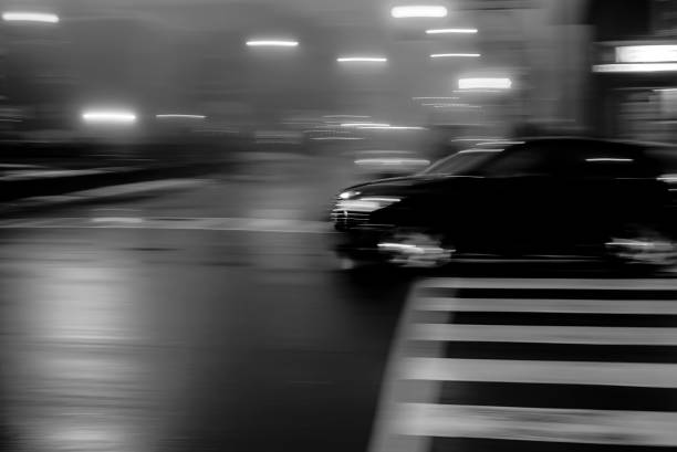 istock BLACK CAR AT NIGHT IN MOTION BLUR 1464327807