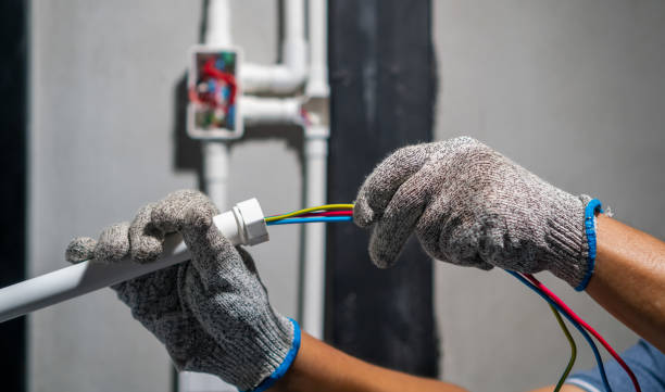 Electrician pulling wire into PVC Conduit. stock photo