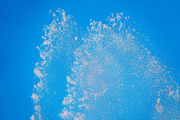 istock Splashes of water against the blue sky background 1464332365