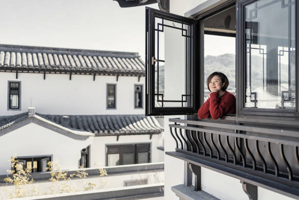 Woman look out from windows at home