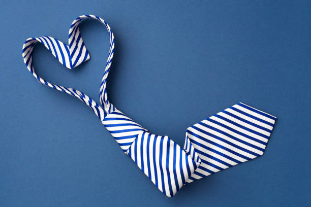 istock Necktie in heart shape on blue background 1464338833