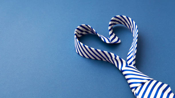 istock Necktie in heart shape on blue background 1464339025