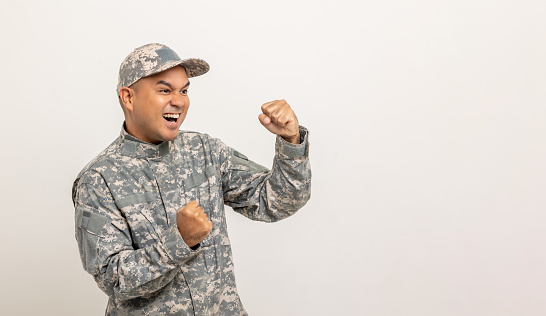 Happy Asian man special forces soldier standing against in studio isolated. Commander Army soldier military defender of the nation in uniform standing on white background.
