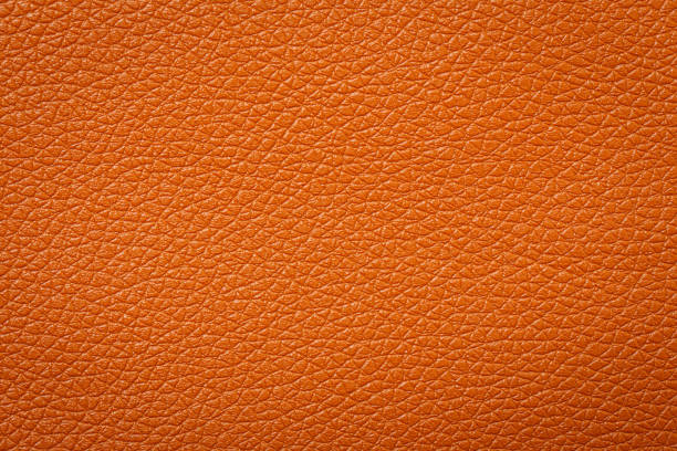 istock Synthetic leather brown background texture. Brown leather textured background. 1464340772