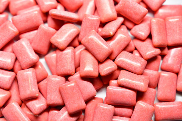 istock Scattered pink chewing gum grains 1464341379