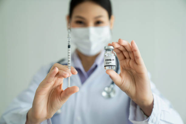 istock Skillful doctor prepare vaccine proficiently before injection . Covid 19 and coronavirus vaccination center service concept . 1464343498