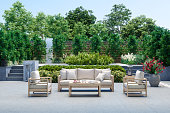 Modern Patio With Sofa, Armchairs, Coffee Table And Garden View Background