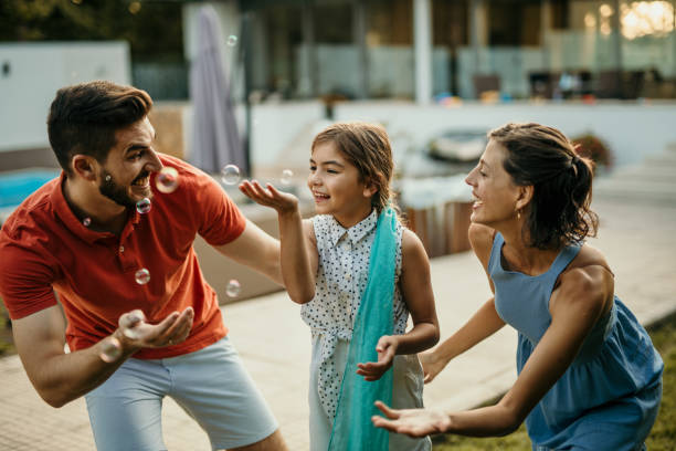 istock Playful family chassing bubbles 1464351664