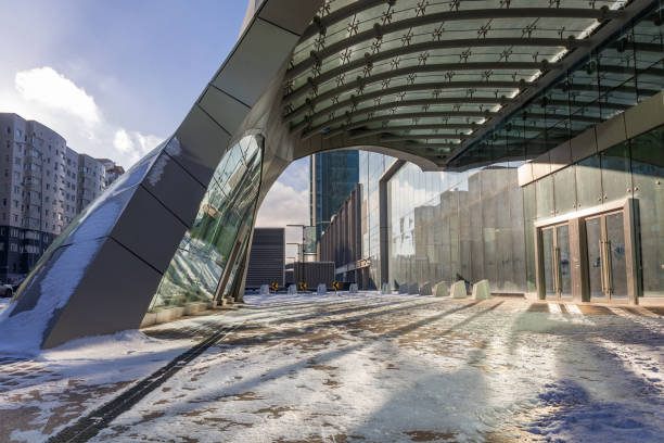 Modern architectural urbanistic entrance to skyscraper. Abstract geometric background with sun reflection and shadows. Interior building with glass windows