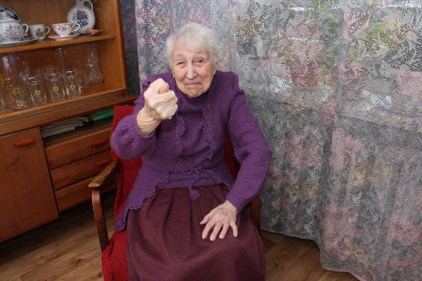 Beautiful portrait of elderly woman with her hands close to face