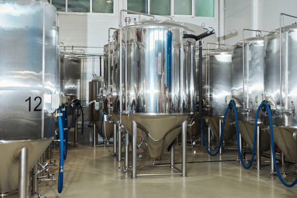 istock Steel fermentation tanks in workshop at industrial factory 1464359288